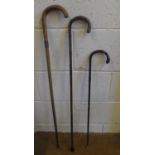 Three antique sticks, all with small silver bands, 2 are walking sticks the other a swagger stick (