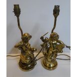 Pair of gilt metal table lamps in the form of Putti playing musical instruments (2) The putti