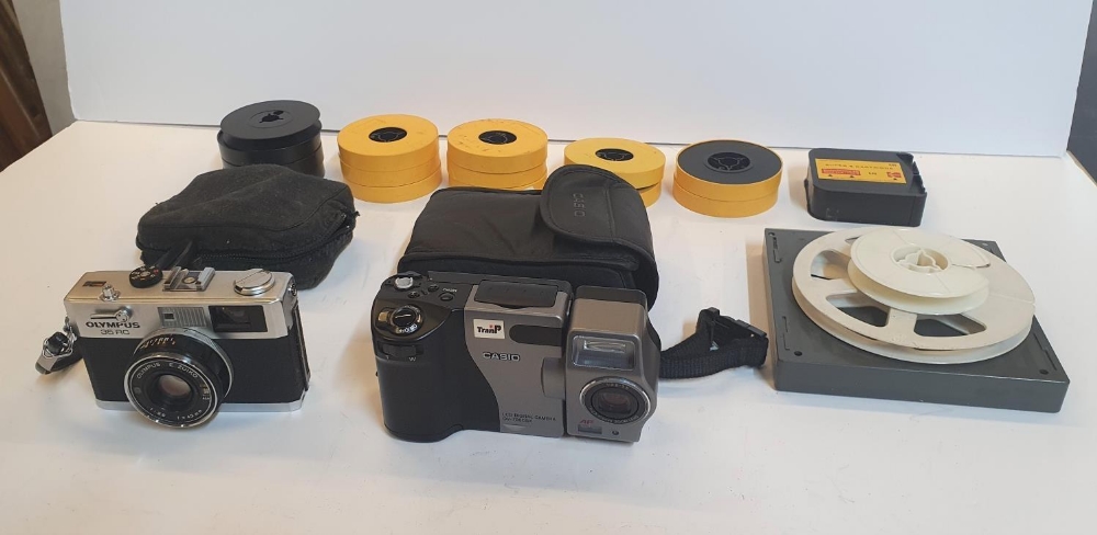 An Olympus 35 RC camera & a Casio digital camera, both with cases together with tape reels etc (lot)