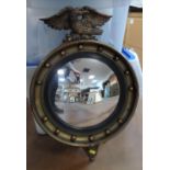20thC circular mirror topped with Eagles head motif, 63 cm high 1 round decorative ball missing