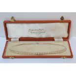 A boxed "Pompadour pearls" ladies pearl necklace with silver clasp setting