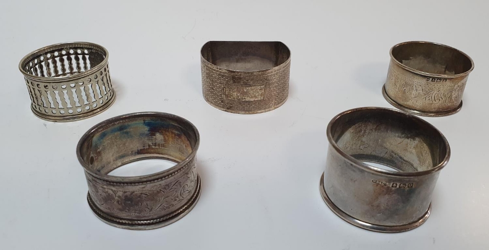 Five silver napkin holders (1 with rubbed marks) all differing patterns, marks etc (5)