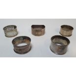 Five silver napkin holders (1 with rubbed marks) all differing patterns, marks etc (5)