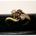 18ct yellow gold ring with a 4 stone setting, 2 garnets, 1 diamond & another clear stone Approx 3.