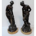 Fine pair of unsigned French 1920s bronze statues on circular marble plinths depicting Grecian