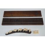 Old boxed Chinese abacus together with antique small carved graduating ivory camels & another