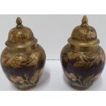 Pair of small enamel covered lidded vases decorated with leaf decoration, Both 11 cm tall