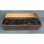 Early 20thC collection of 6 matching batteries housed in their original purpose built box, 71 cm