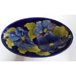 Moorcroft Clematis on dark blue back-ground, shallow oval dish, 23 cm, signed to underside 14 x 23