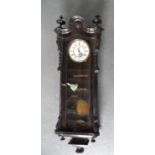 Large antique ebonised ornate wooden wall clock, complete with key, unmarked, 115 cm long, R1 near
