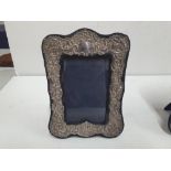 Edwardian hallmarked silver photo frame together with another similar, unmarked example (2)