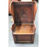 Antique oak lambing chair with storage compartment beneath the seat,