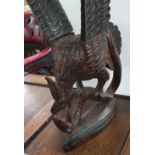 Antique Folk Art, hand-carved wooden statue depicting an Eagle fighting with a snake. The wings