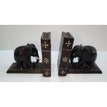 Pair of ebonised wood, book ends in the form of Elephants, both with hidden compartments