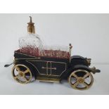 Metal model vintage car holding a decanter & shot glasses. 35 x 25 cm