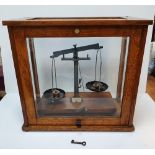 Cased set of balance scales (complete) by Phillip Harrison of Birmingham, 46 cm long, Small crack to