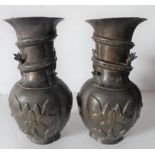 Pair of antique Chinese bronze vases, stamped to base, with wrap around mythical creatures to vase