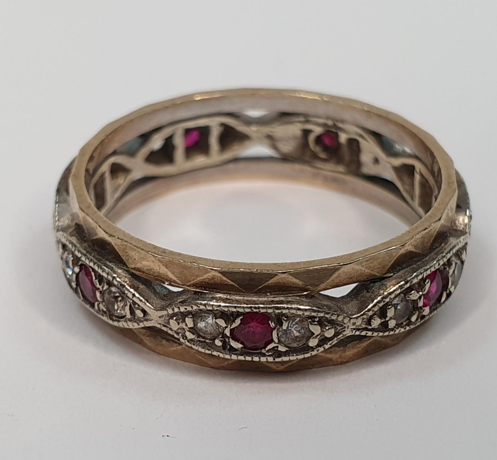 Unmarked metal eternity ring inset with diamonds & rubies round the entire ring, 3.5 grams gross,