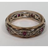 Unmarked metal eternity ring inset with diamonds & rubies round the entire ring, 3.5 grams gross,