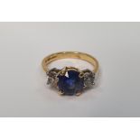 18ct yellow gold ring set with a central Sapphire (approx 2.2cts) flanked to either side by a