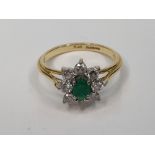 18ct yellow gold ring set with an oval cut Emerald surrounded by 8 round cut diamonds, each