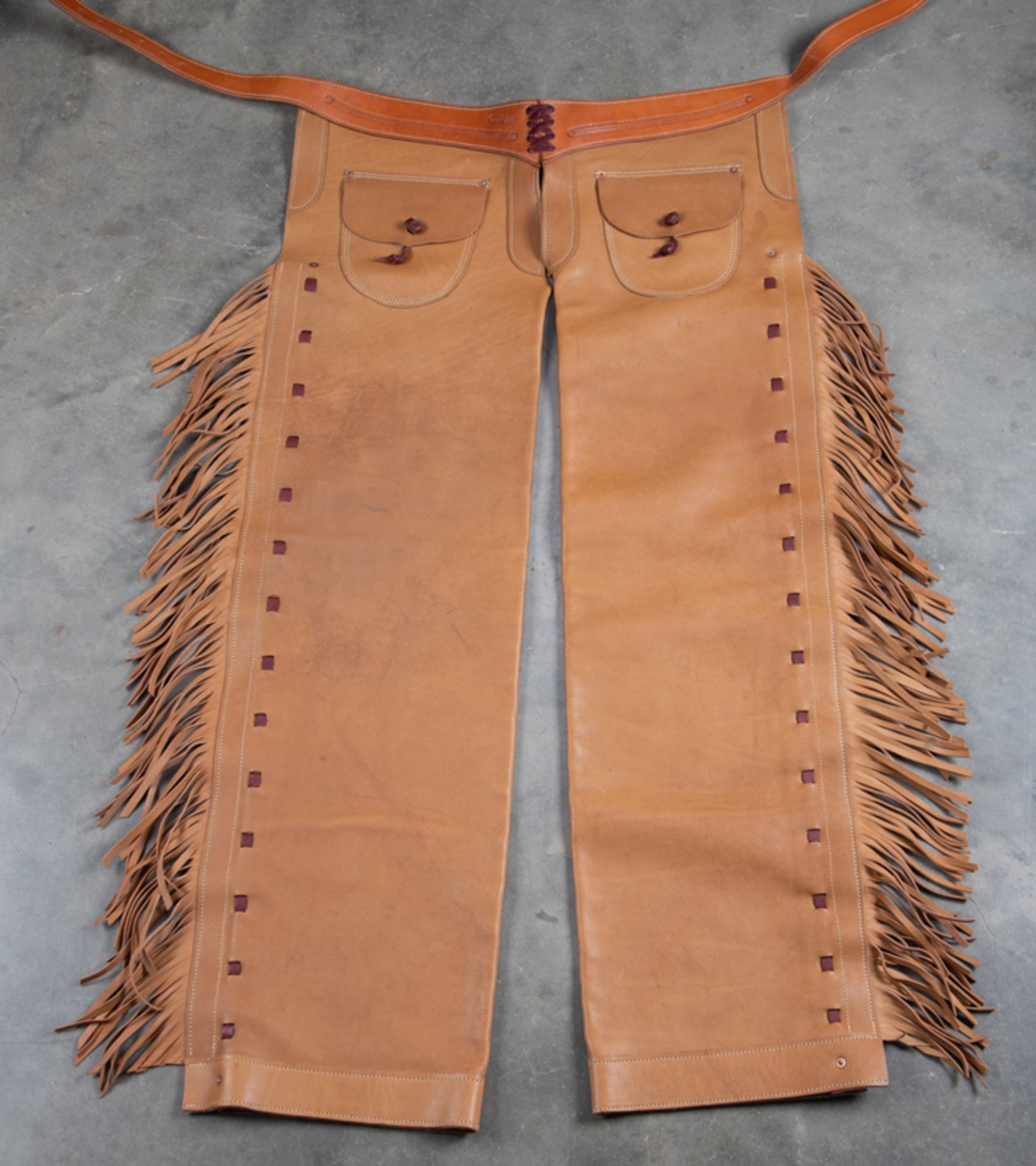 Outstanding pair of leather step in Chaps with fringed border, outside pockets, marked "F.A. Meanea