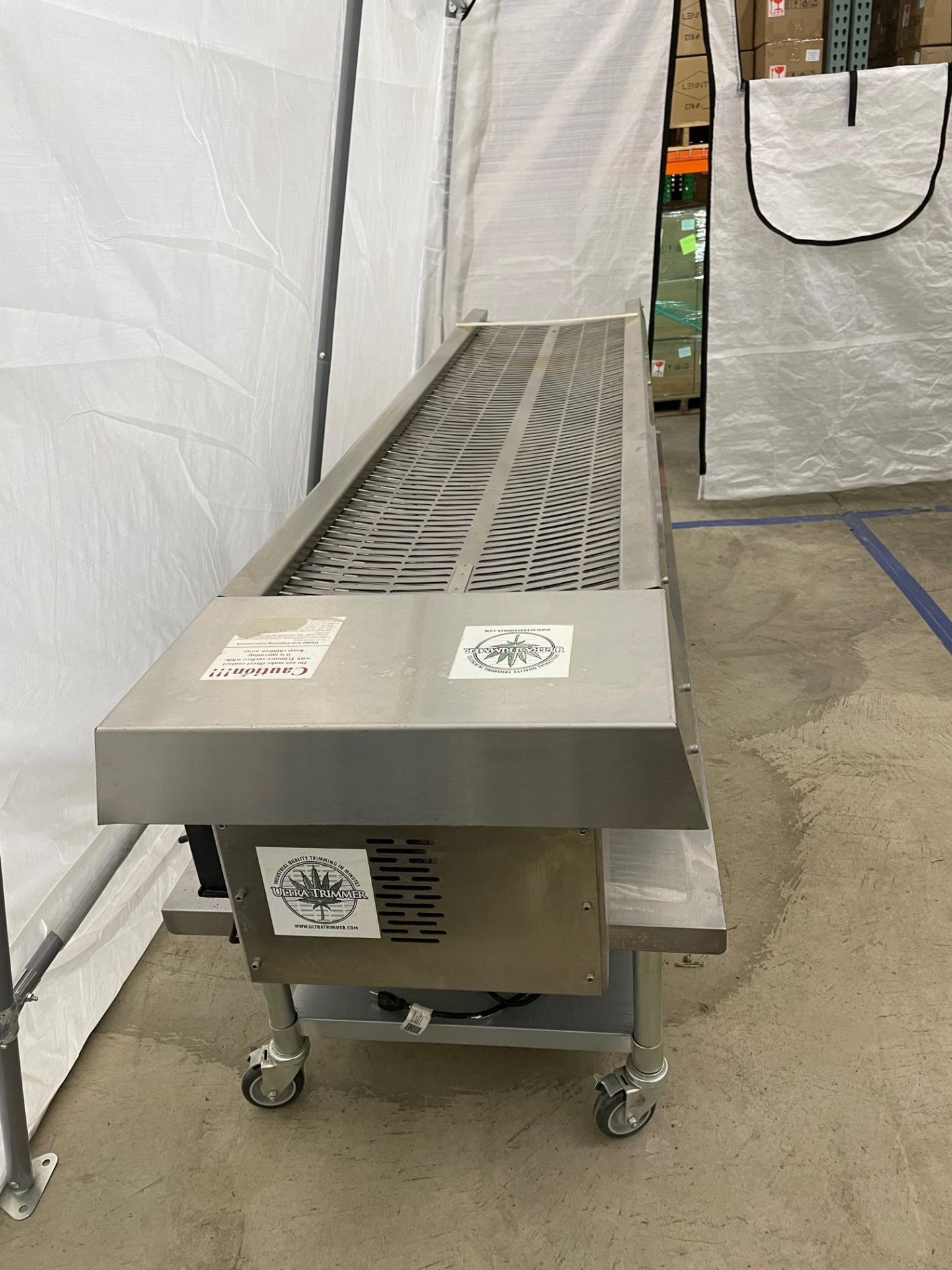 Used UT 4000 Ultra Trimmer. Model UT 400. Includes custom stainless steel table with casters.