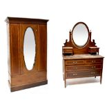 An Edwardian inlaid mahogany mirrored wardrobe with single door over a long drawer,