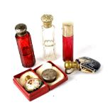 Five late 19th and early 20th century perfume bottles to include two cranberry glass examples,
