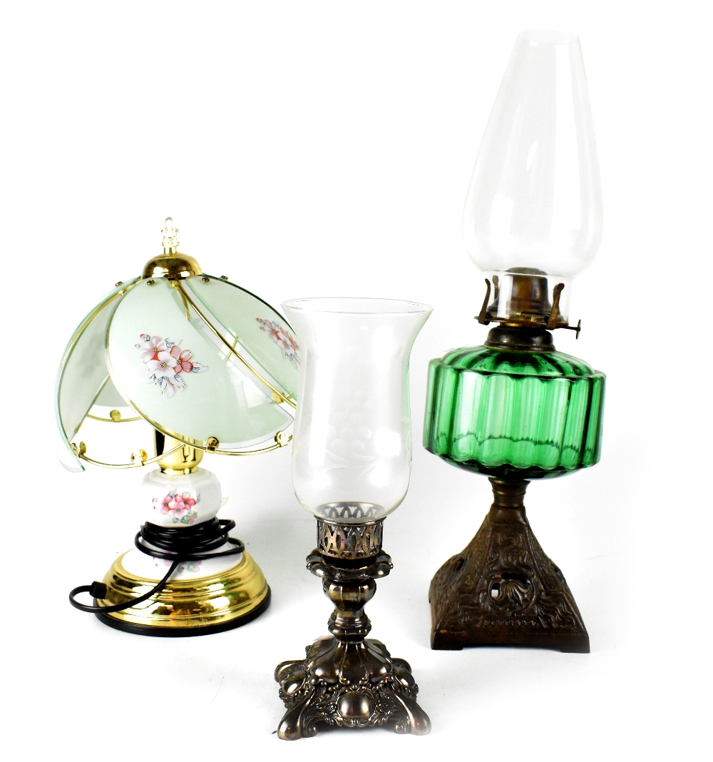 An Edwardian oil lamp with green glass reserve to an Art Nouveau metal base, height 49cm,