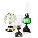 An Edwardian oil lamp with green glass reserve to an Art Nouveau metal base, height 49cm,