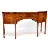 A George III mahogany bow-fronted sideboard with central drawer flanked by two deep drawers,