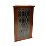 An Edwardian inlaid mahogany wall-hanging cupboard with leaded glazed cupboard door,