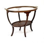 An Edwardian inlaid mahogany oval two-tier tea table with a twin-handled glass top above an