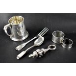 A small group of hallmarked silver items to include a Christening mug, two napkin rings,
