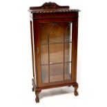 A reproduction display cabinet with carved gallery,