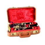 A cased 'Couture Paris' clarinet and five Boosey & Hawkes clarinet reeds.