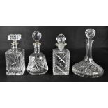 Four cut glass decanters to include a ship's decanter,