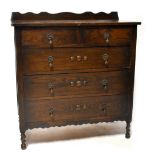 A 1920s oak chest of two short over three long drawers,