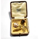 A 9ct gold bar memorial brooch set with garnet and seed pearls within filigree borders with locket