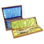 A Victorian cased three-piece horn handled carving set with hallmarked silver mounts in the form of