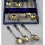 A cased set of six silver plated teaspoons with stylised rose-form finials,