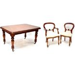 A Victorian-style mahogany wind-out dining table on bulbous turned and carved legs with castors,