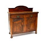 An Art Nouveau sideboard with carved gallery to top,