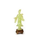An Oriental jade-style figure of a beautiful young woman carrying lotus blossom,