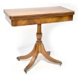 A 19th century style mahogany fold-over card table on a turned column with four outswept legs to