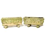 A pair of cast stone-effect trough planters with Green Man style decoration,