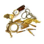 Ten various pocket watch keys, a gilt metal magnifying glass on a chain,