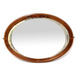 An Edwardian mahogany-framed oval bevel edged wall mirror, 61 x 84.5cm.