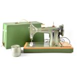 A vintage Jones cased electric sewing machine.